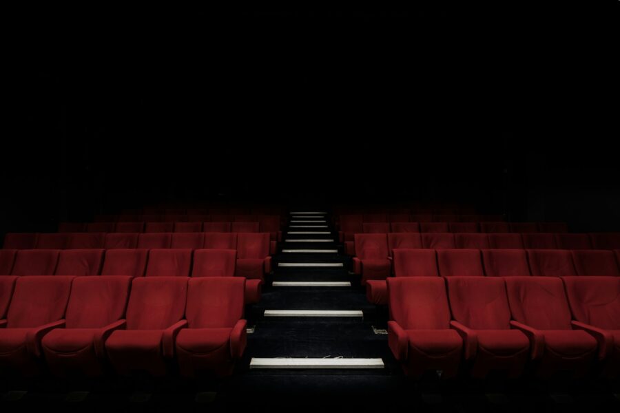 Vaikai kino salėje žiūri animacinį filmą didžiajame ekrane