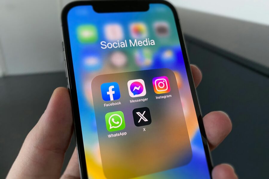 Žmogus telefone naršo socialinių tinklų srautą, kurį formuoja rekomendacijų algoritmai